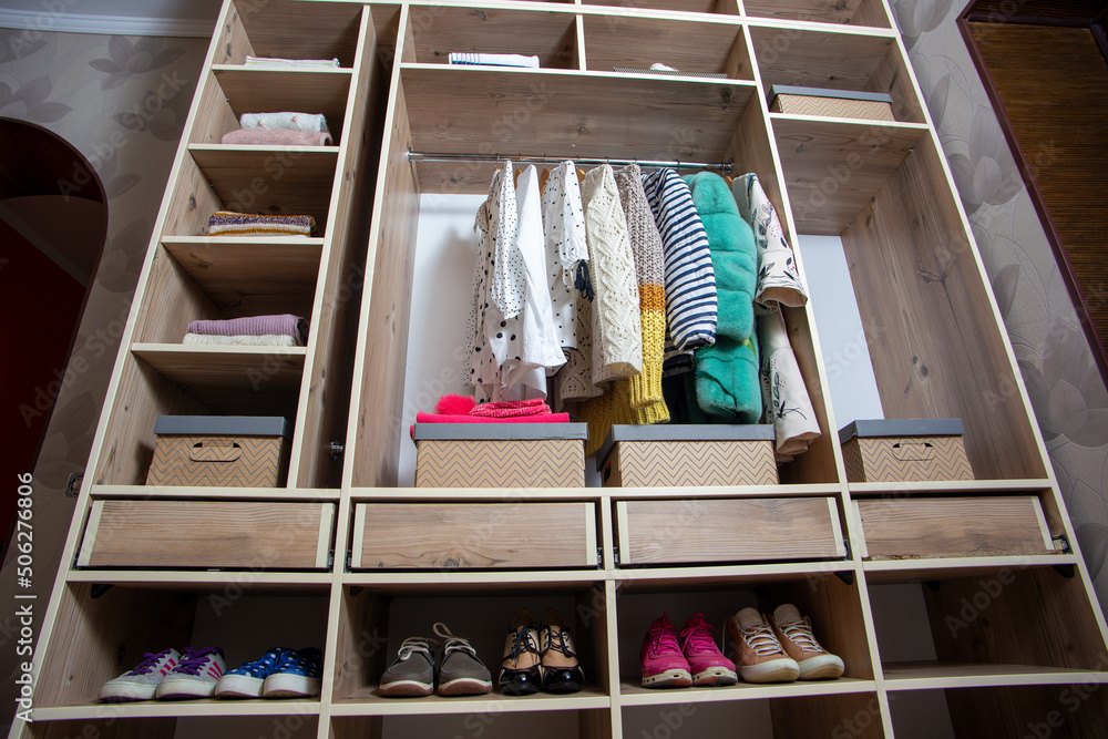 Big wardrobe with different clothes and accessories in dressing room Big wardrobe with different clothes and accessories in dressing room