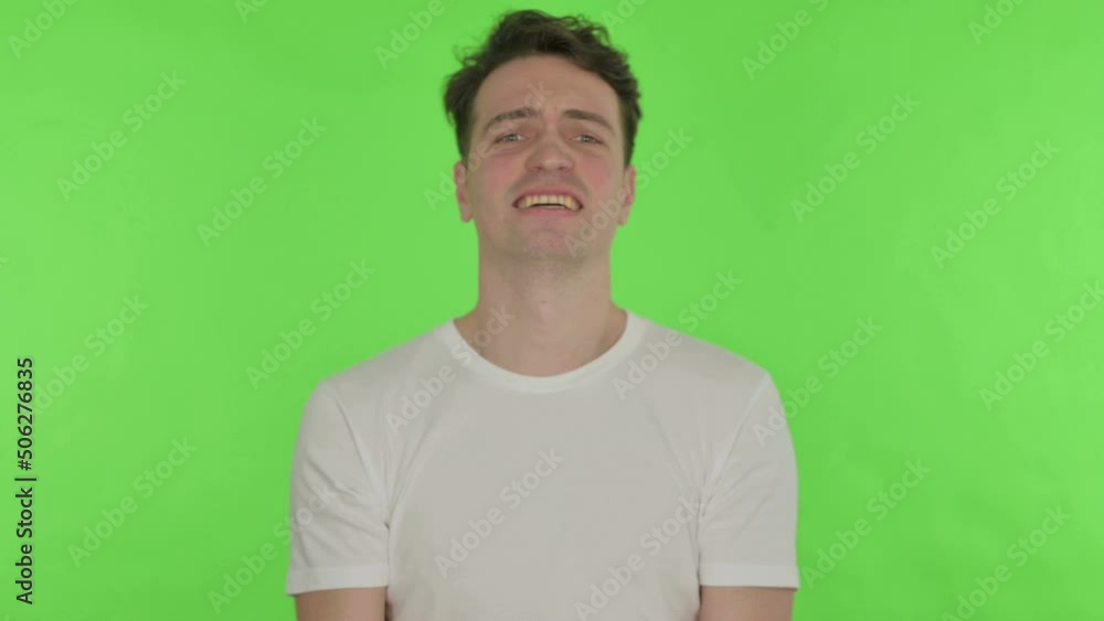 Young Man Shouting and Screaming on Green Background Young Man Shouting and Screaming on Green Background