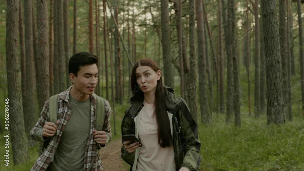 Young couple hiking in a forest Young couple hiking in a forest
