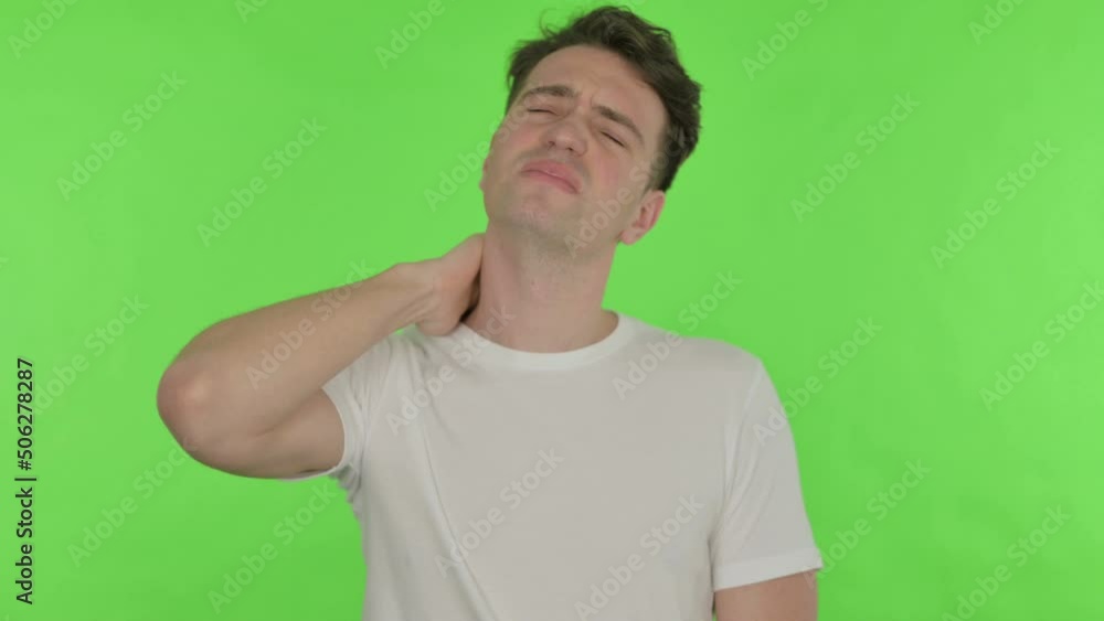Young Man with Neck Pain on Green Background Young Man with Neck Pain on Green Background