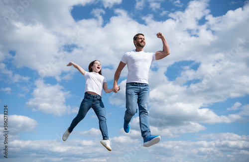 happy father and daughter jump in sky. freedom