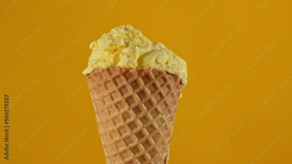 Banana ice cream rotating at yellow background. Yummy yellow ice cream. Food concept. Close-up in 4K, UHD Banana ice cream rotating at yellow background. Yummy yellow ice cream. Food concept. Close-up in 4K, UHD
