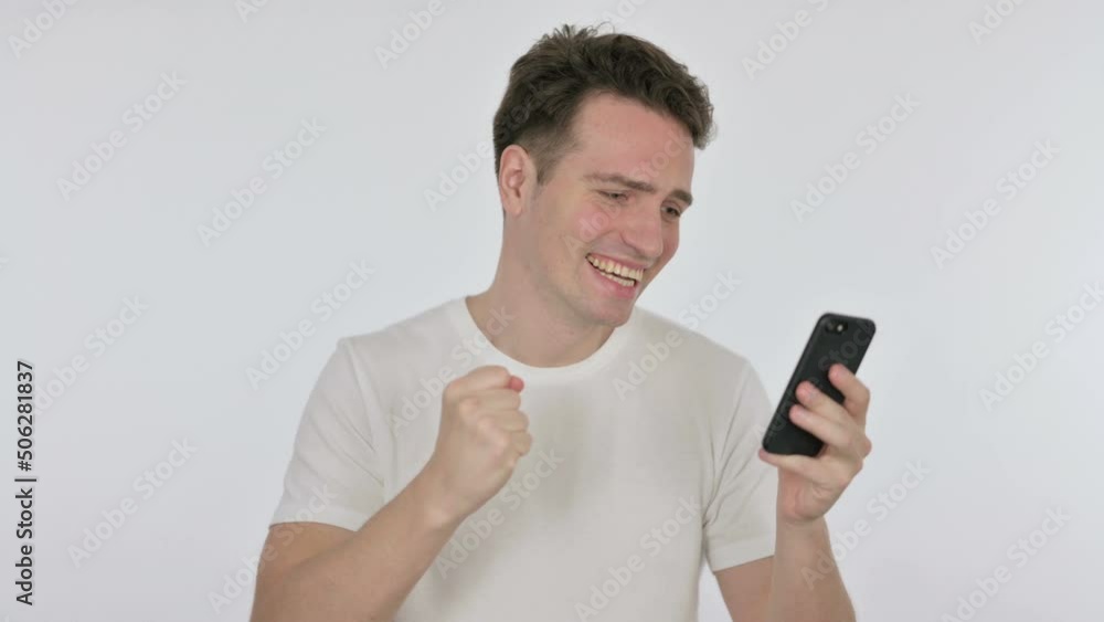 Young Man Celebrating on Smartphone on White Background Young Man Celebrating on Smartphone on White Background