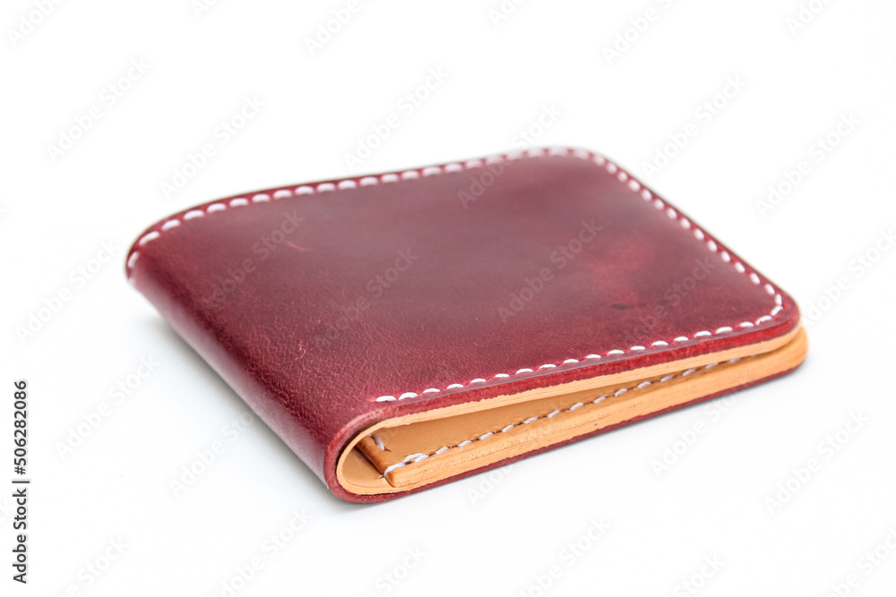 Red or Maroon natural leather wallet isolated on a white background. Closeup expensive wallet. Leather craft. Homemade. Red or Maroon natural leather wallet isolated on a white background. Closeup expensive wallet. Leather craft. Homemade.