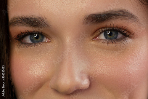 Macro shot of woman's beautiful eye with extremely long eyelashes. Sexy view, sensual look. Female eye with long eyelashes