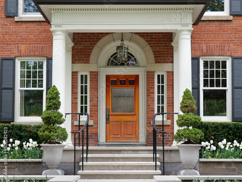 House with portico entrance and elegant wood grain front door