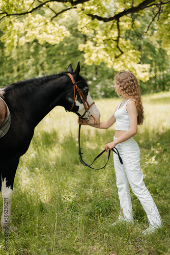 Beautiful girl with a horse for a walk