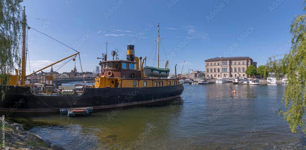 Fototapeta premium Transport boat at a pier a sunny day in Stockholm