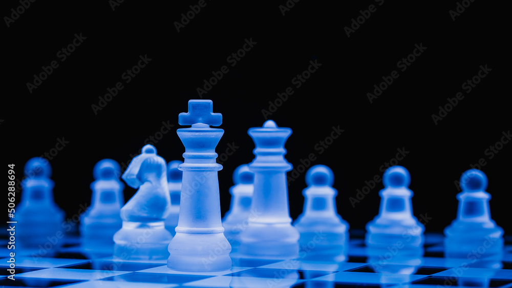 Glass chess, on the black background. Stock images. Close-up view