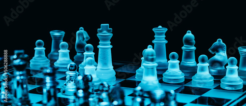 Glass chess, on the black background. Stock images. Close-up view