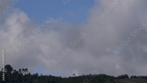 Movement of clouds in the sky and mountains on the horizon, space open to nature with sunlight. Strong winds.