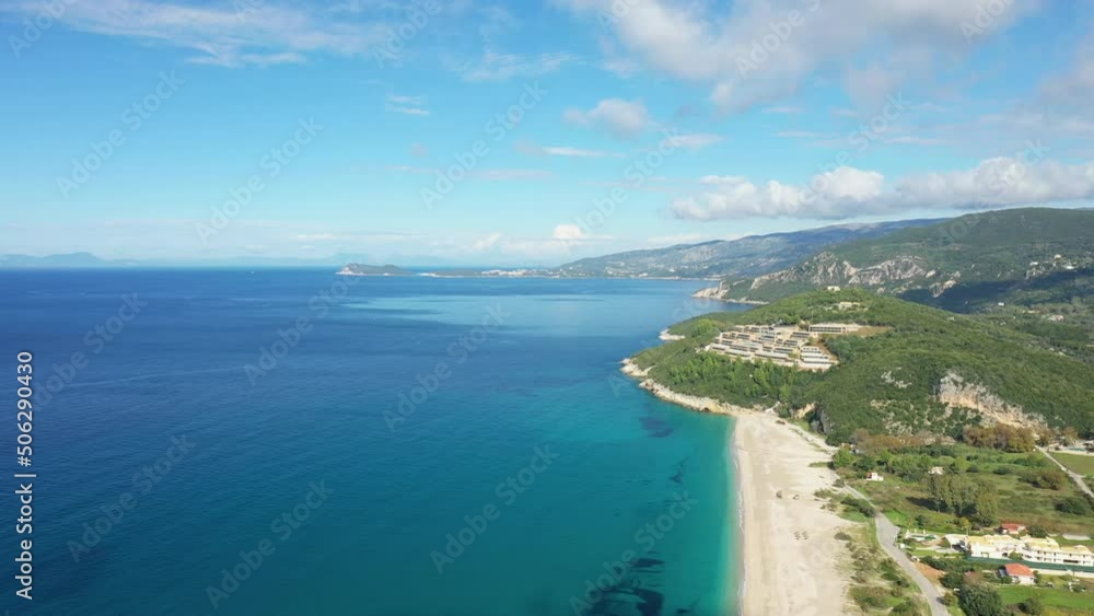 The panoramic view of Karavostasi beach on the edge of the Ionian Sea in Europe, Greece, Epirus, in the summer on a sunny day. The panoramic view of Karavostasi beach on the edge of the Ionian Sea in Europe, Greece, Epirus, in the summer on a sunny day.