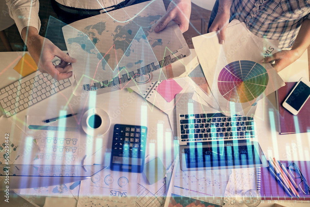 Double exposure of man and woman working together and financial chart hologram drawing. market analysis concept. Computer background. Top View. Double exposure of man and woman working together and financial chart hologram drawing. market analysis concept. Computer background. Top View.
