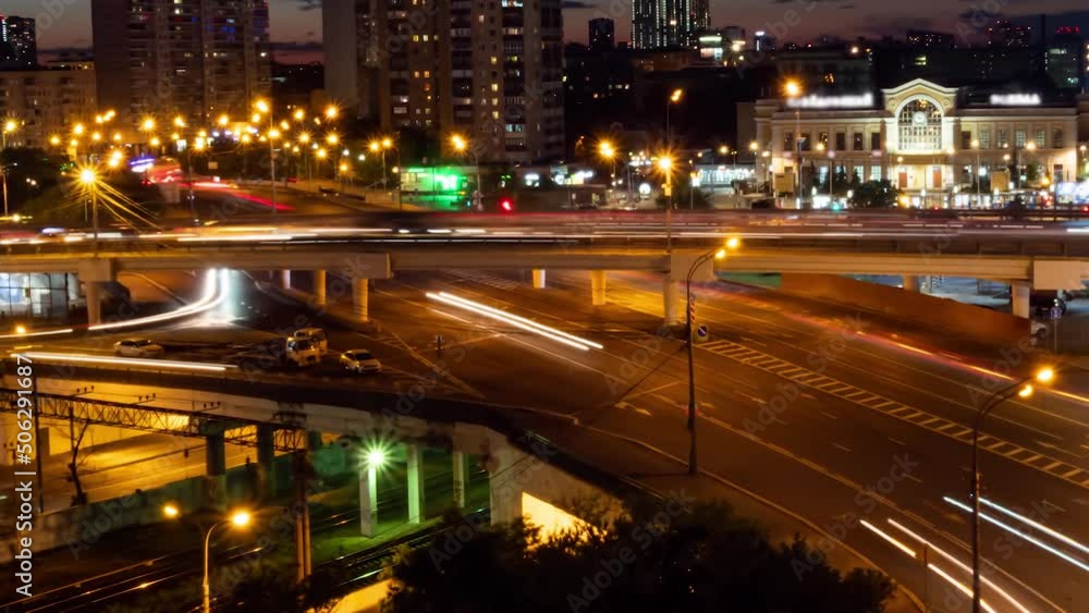Timelapse: city highway traffic - street with fast moving cars and lights trails. Warm illumination at night: zoom in shot. Time lapse, rush hour, urban, transportation and city life concept Timelapse: city highway traffic - street with fast moving cars and lights trails. Warm illumination at night: zoom in shot. Time lapse, rush hour, urban, transportation and city life concept
