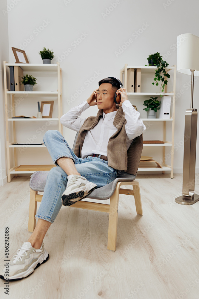 man in headphones sits on a chair rest music Lifestyle