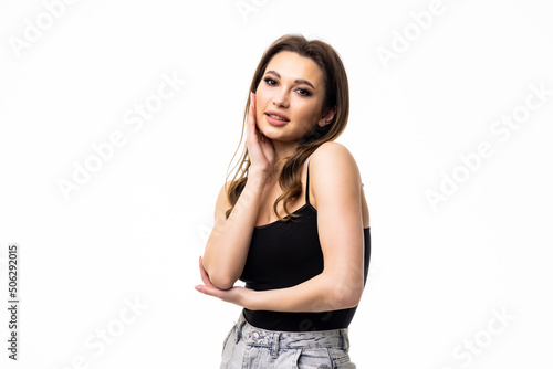 Young woman with short hair, smiling and looking cute at camera standing against white background. © F8  \ Suport Ukraine