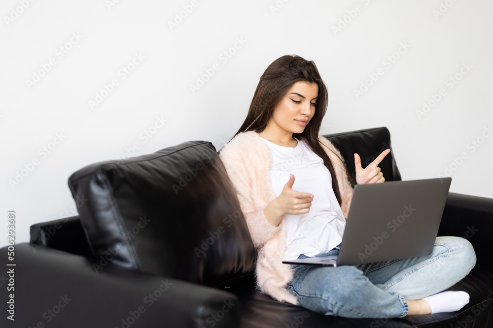 Young happy woman holding video call, gesturing hi to friends, relatives or parents. Attractive female blogger recording new video to followers. Smiling girl having online interview with employer. Young happy woman holding video call, gesturing hi to friends, relatives or parents. Attractive female blogger recording new video to followers. Smiling girl having online interview with employer.