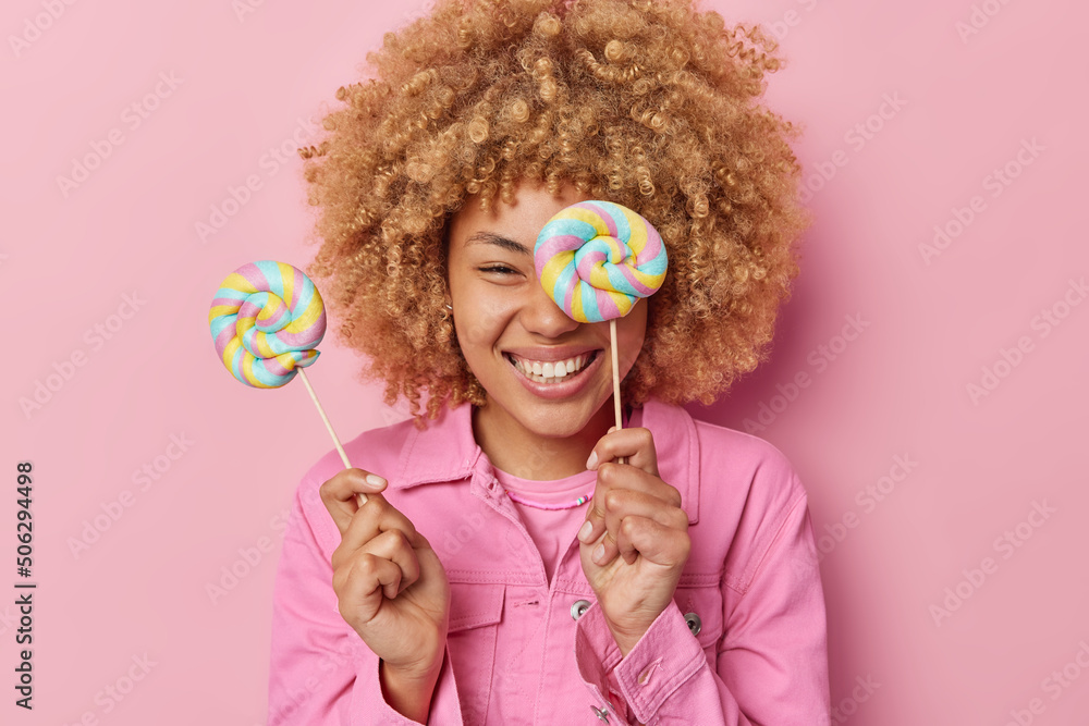 Sweet life living. Positive carefree woman poses with caramel candies ...