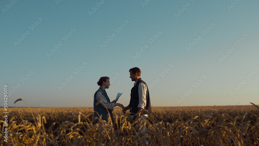 Two farmers meeting wheat field sunlight. Successful agriculture business deal.