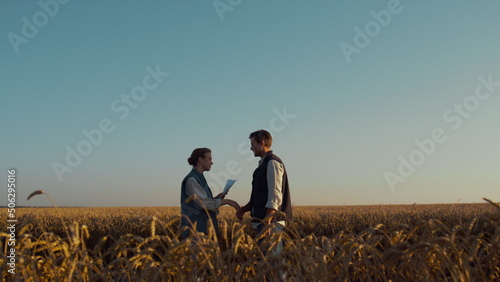 Two farmers meeting wheat field sunlight. Successful agriculture business deal.