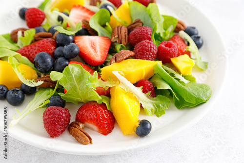 Fruit and berry salad with strawberry  blueberry  raspberry  mango and pecan nuts. Healthy food  diet