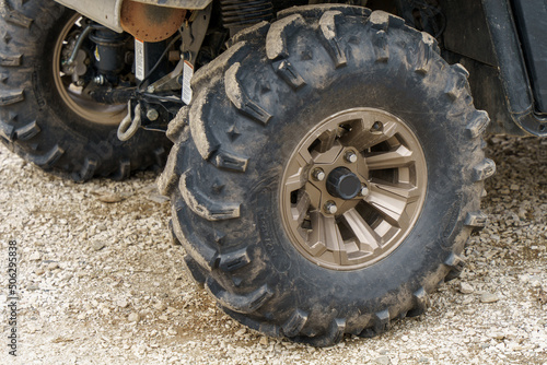 dirty ATV wheel in parking lot