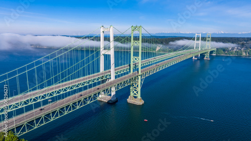 Aerial view of the Narrows bridge in Tacoma Washington with clouds drifting in