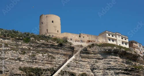 View of Bonifacio stairs and the limestone cliff in Corsica, France- Vue sur l'escalier de la ville de bonifacio creusé dans les falaises de calcaire en Corse, France