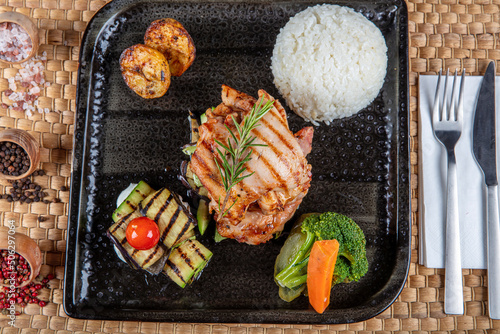 Grilled chicken breast, tomatoes, stir-fry eggplant and broccoli, and rosemary. Homemade food. Concept for a delicious and healthy meal. Turkish cuisine.