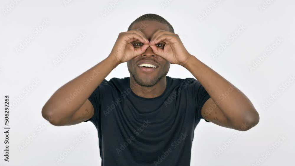 Searching Young African Man with Binocular Gesture on White Background