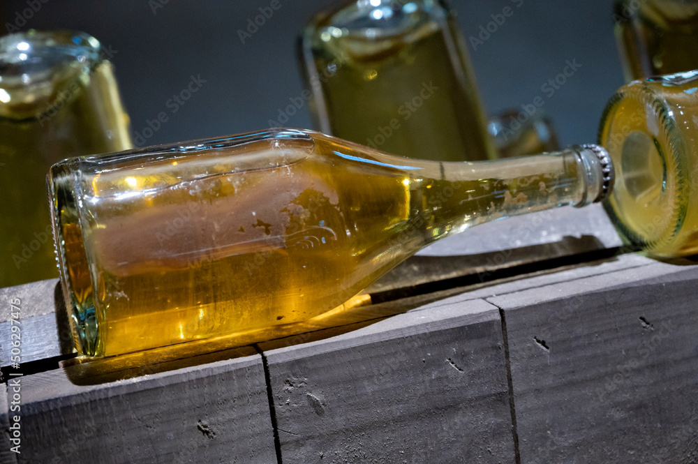Sparkling wine production by traditional methods in underground cellars in Vienna, Austria. Sediment in bottle. Sparkling wine production by traditional methods in underground cellars in Vienna, Austria. Sediment in bottle.