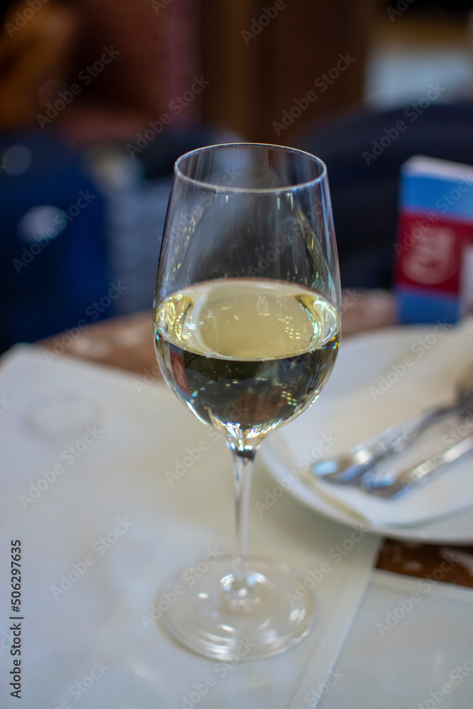 Obraz premium Lifestyle of beautiful Vienna, glass of white dry Austrian wine served in old Viennese-style cafe in Vienna, Austria