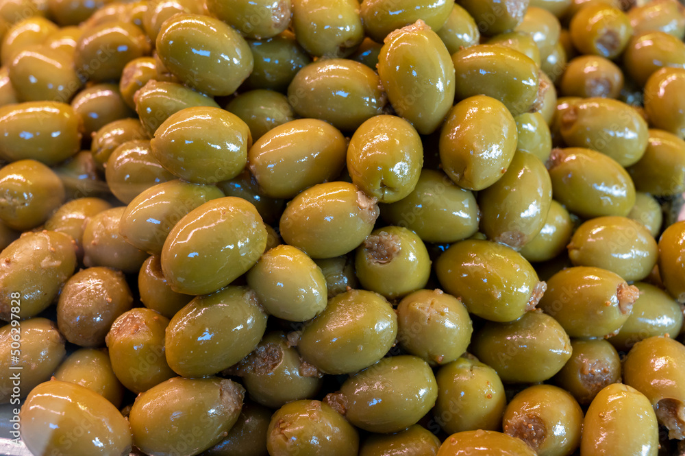 Green fresh olives close up on market, food background Green fresh olives close up on market, food background