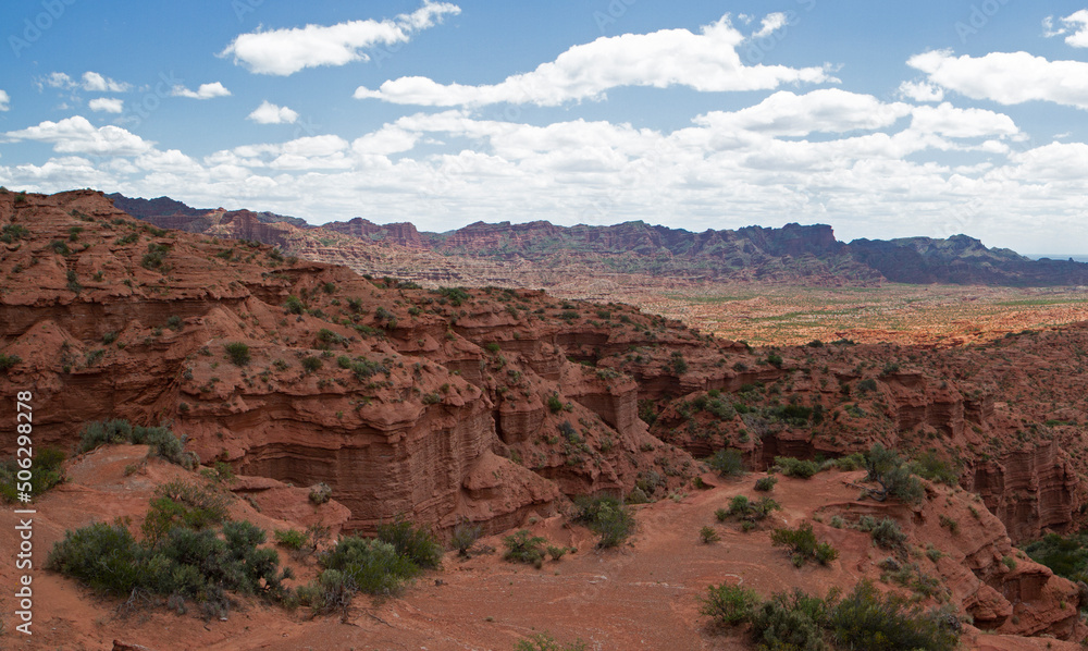 Desert landscape. Panorama view of the red canyon, sandstone and rock cliffs, mountains and valley.