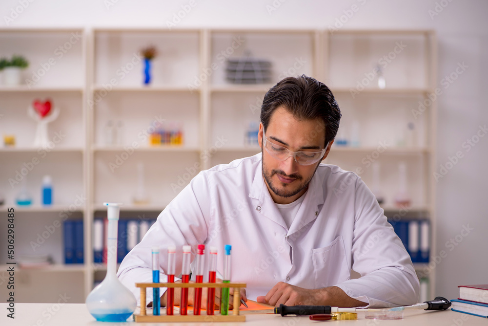 Young male chemist working at the lab Young male chemist working at the lab