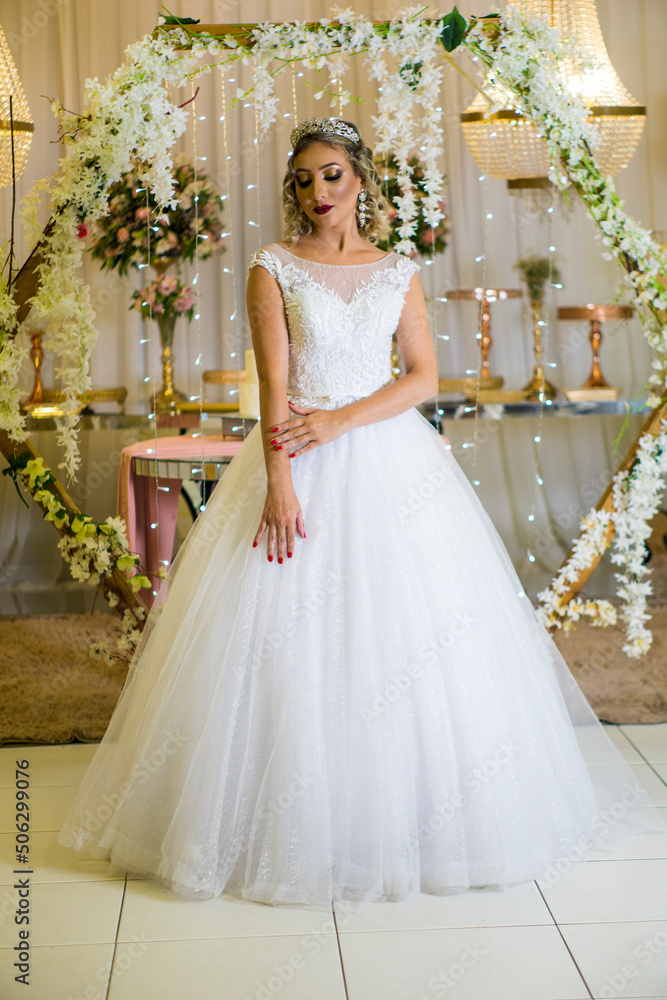 young caucasian brazilian bride at her wedding with decorated background, makeup and hairstyle. young caucasian brazilian bride at her wedding with decorated background, makeup and hairstyle.