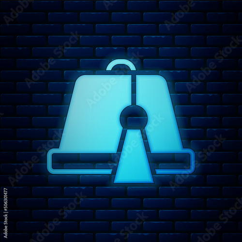 Glowing neon Turkish hat icon isolated on brick wall background. Vector