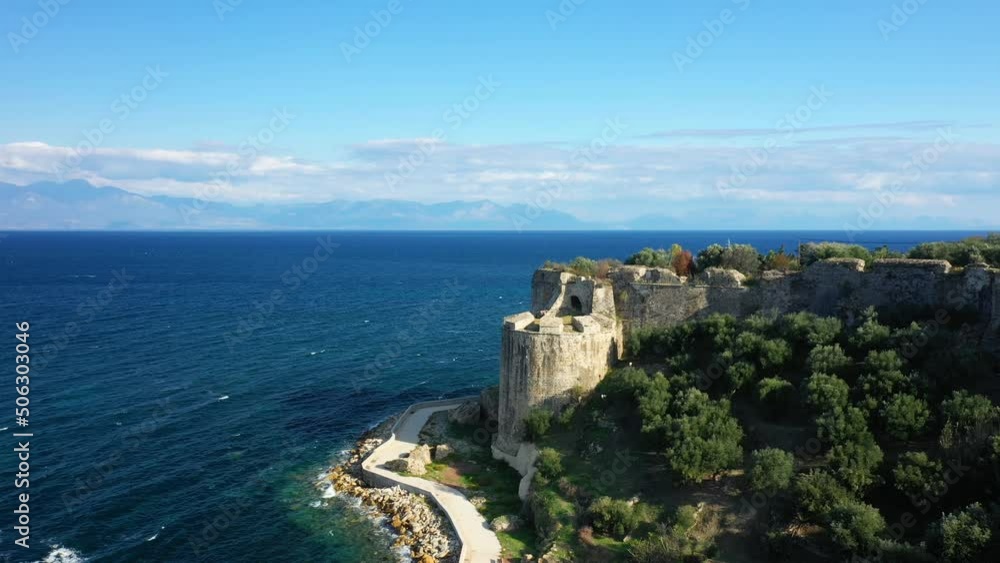 A road at the foot of Koroni Castle facing the Mediterranean Sea in Europe, Greece, Peloponnese, Mani, in summer, on a sunny day. A road at the foot of Koroni Castle facing the Mediterranean Sea in Europe, Greece, Peloponnese, Mani, in summer, on a sunny day.