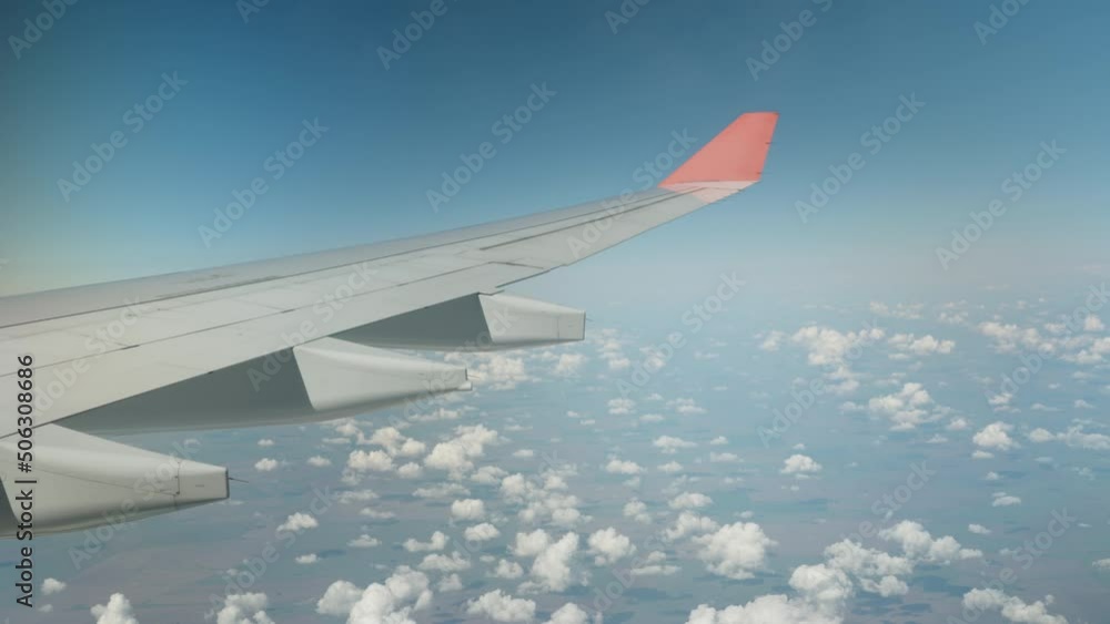 The wing of the plane is in the clouds. The plane turns. The wing of the plane is in the clouds. The plane turns.