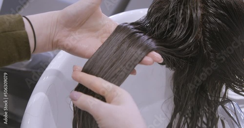 Hairdressing close-up with brunette woman, coloration, cut, brushing photo