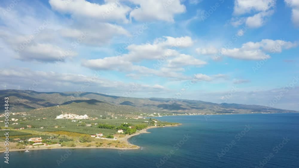 The Myrto Sea and the green countryside in Europe, Greece, Peloponnese, Argolis, towards Hermione, in summer, on a sunny day. The Myrto Sea and the green countryside in Europe, Greece, Peloponnese, Argolis, towards Hermione, in summer, on a sunny day.
