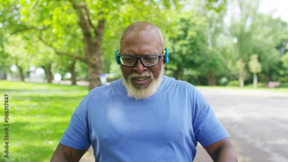 Senior black male getting his breath back after a workout in the park, in slow motion Senior black male getting his breath back after a workout in the park, in slow motion