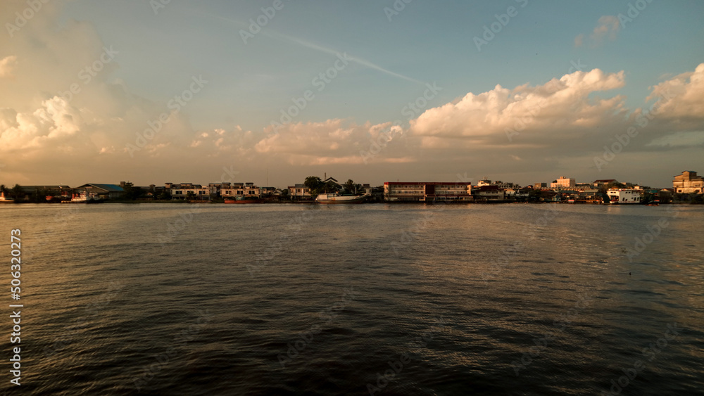 Afternoon walk on the city waterfront. Sunset at waterfront. Kapuas river, Pontianak, Indonesia.