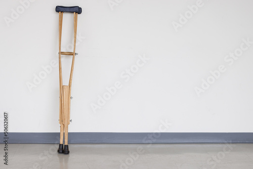 wooden crutches on white wall.