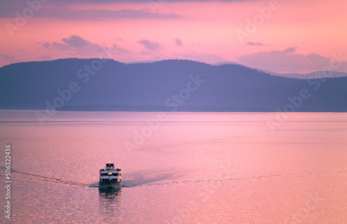 Lake Champlain, New England, USA. Cruise boat called Ethan Allen looking west from Vermont shore at Burlington to New York State photo