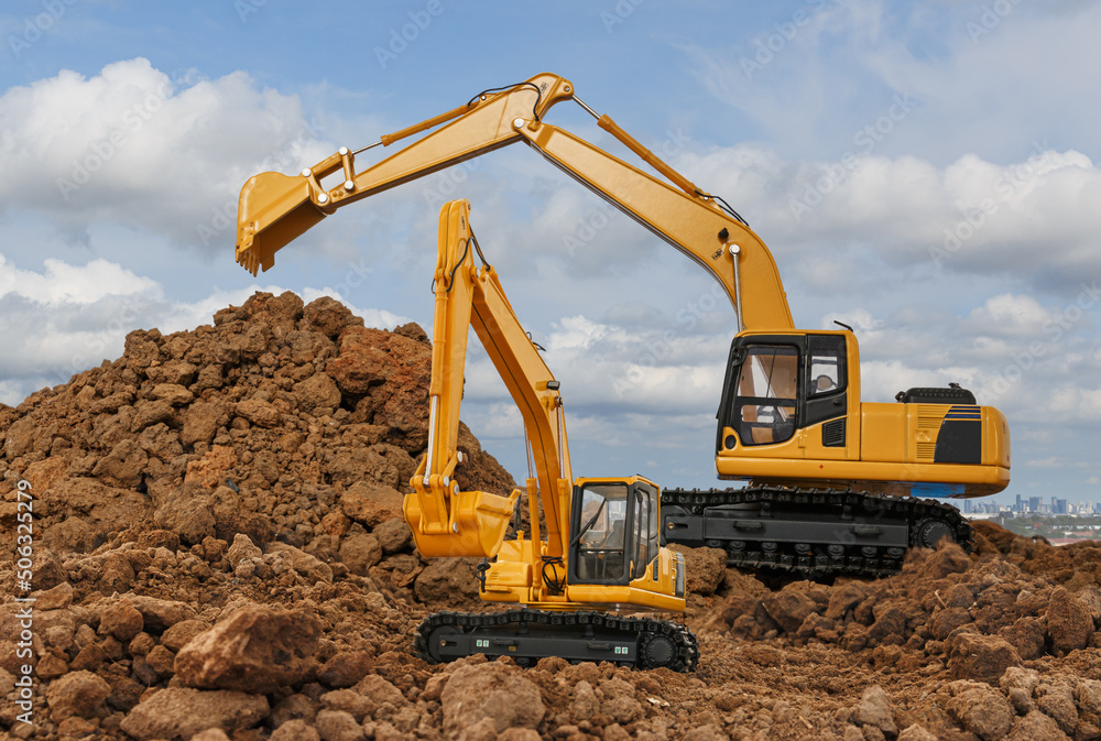 Two crawler excavator is digging in the construction site work with sky background Two crawler excavator is digging in the construction site work with sky background
