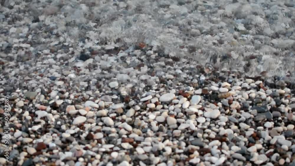 Top view video of waves on a stone pebble beach Top view video of waves on a stone pebble beach