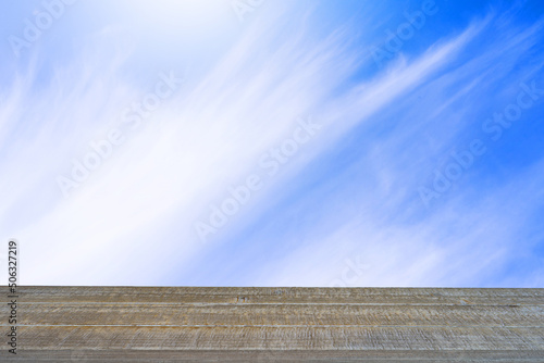 Abstract Old Wooden Table Against Flowing Clouds Sky Background.