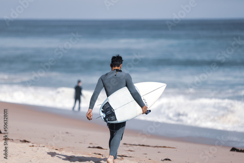 Surfer entering water