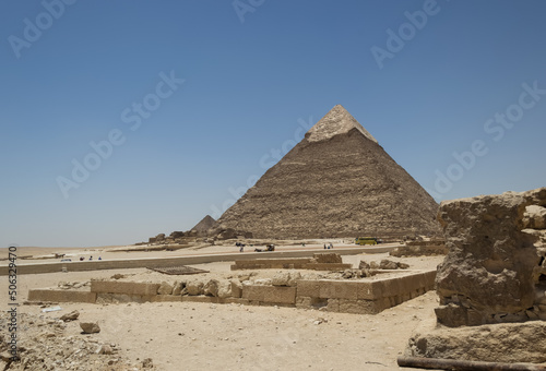 Architectural detail of the Giza pyramid complex located about 13 kilometers southwest of Cairo s city center. In the background  the Pyramid of Khafre or of Chephren